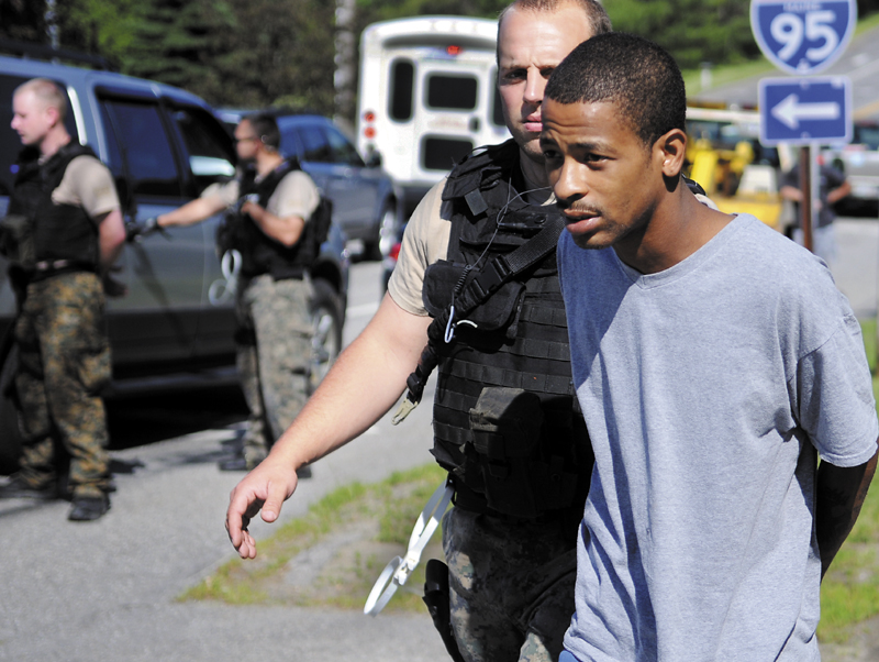 Augusta Police escort a man apprehended by Maine Drug Enforcement Agents Wednesday in Augusta to a police car. Three people were arrested following a traffic stop, according to Maine Drug Enforcement Agency Supervisor Lowell Woodman.