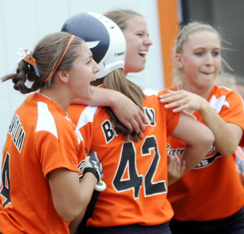 HAPPY DAYS: Gardiner Area High School softball players greet Briana Brochu after scoring Monday against Hermon in an Eastern Class B semifinal game in Gardiner.