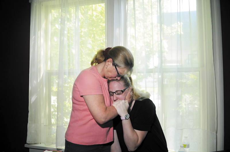 Leslie Ellis comforts her daughter, Amber, Wednesday at their Augusta home as they grieve for their son and brother, Jordan Ellis. A 2012 Cony High School graduate, Jordan died last Friday in Augusta from a presumed heroin overdose.