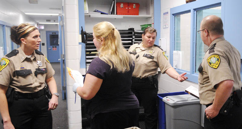 Kennebec County Corrections Facility officers and staff check a cell block Thursday at the jail in Augusta.