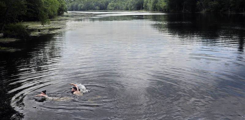 Desiree Johns, left, of Sabattus, and Brandon Bouchard, of Greene, swim in Cobbossee Stream on Monday in Litchfield. The friends were taking a respite from temperatures that rose into the upper 80s. Forecasts call for higher temperatures and chances of thunderstorms for the remainder of the week. "The water is just lovely," Johns said.