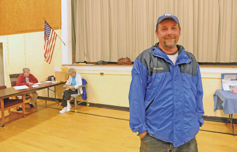 Leo Hill, 42, stands in the gymnasium at Quimby Middle School in Bingham on Tuesday after voting on the Regional School Unit 18 budget.