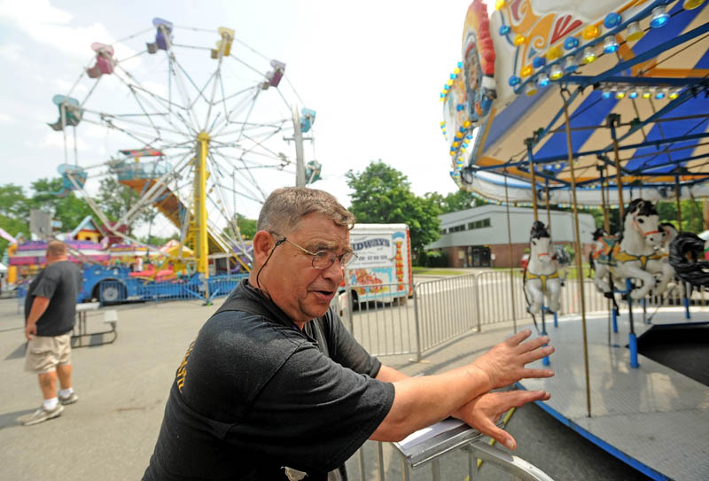 Stephen Dixon, a state fire marshal's office inspector, inspects a merry-go-round at the East Coast Midways carnival in Fairfield on Tuesday.