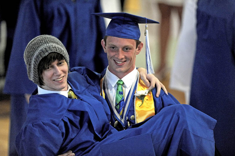 Mason Travers holds his friend, Jon Beane, in the gymnasium before commencement ceremonies at Lawrence High School in Fairfield on Thursday.