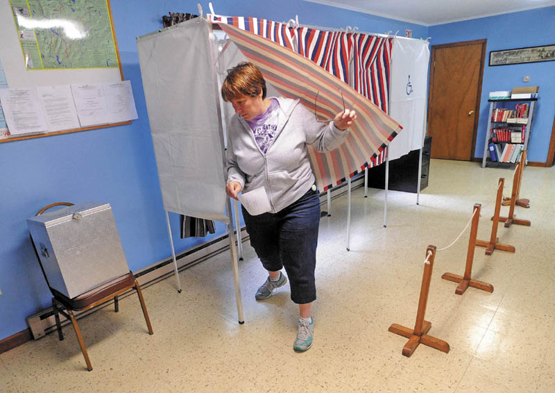 Wendy Belanger, 45, exits the polling booth at the Moscow Town Office on Tuesday after voting on the Regional School Unit 18 budget.