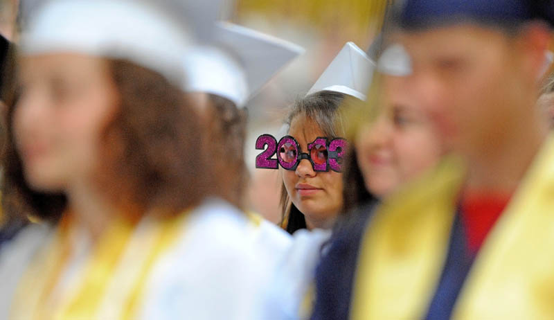 Caley Miranda, center, sports "2013" glasses during My. Blue High School's commencement ceremonies in Farmington on Saturday.