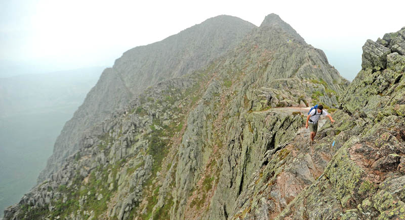 Jesse Hamilton, of Waterville, traverses the Knife Edge on Mt. Katahdin in Baxter State Park on Sunday. Mt. Katahdin is the highest mountain in Maine and the northern terminus for the Appalachian Trail. The Knife Edge route offers spectacular views along it's narrow razor like ridge that connects Pamona Peak to Baxter Peak.