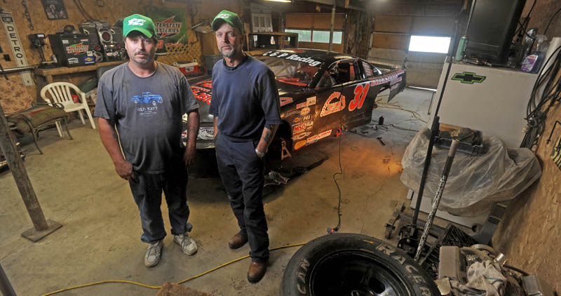NEW CHALLENGE: Unity Raceway Late Model driver Brent “Poochie” Chase, left, and his crew chief Kevin Poulin, stand by the car in Poulin’s garage in Detroit on Friday. Chase is racing Late Models for the first time and Poulin is a crew chief for the first time.