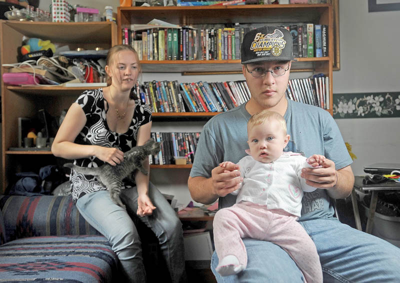 Kevin Hardy is one of two males to graduate from the Teen Parent School program at the Maine Children's Home for Little Wanderers in Waterville. With him is his infant daughter, Zoey, and fiancee, Wendy Joler, at Hardy's mother's Winslow residence on Friday.
