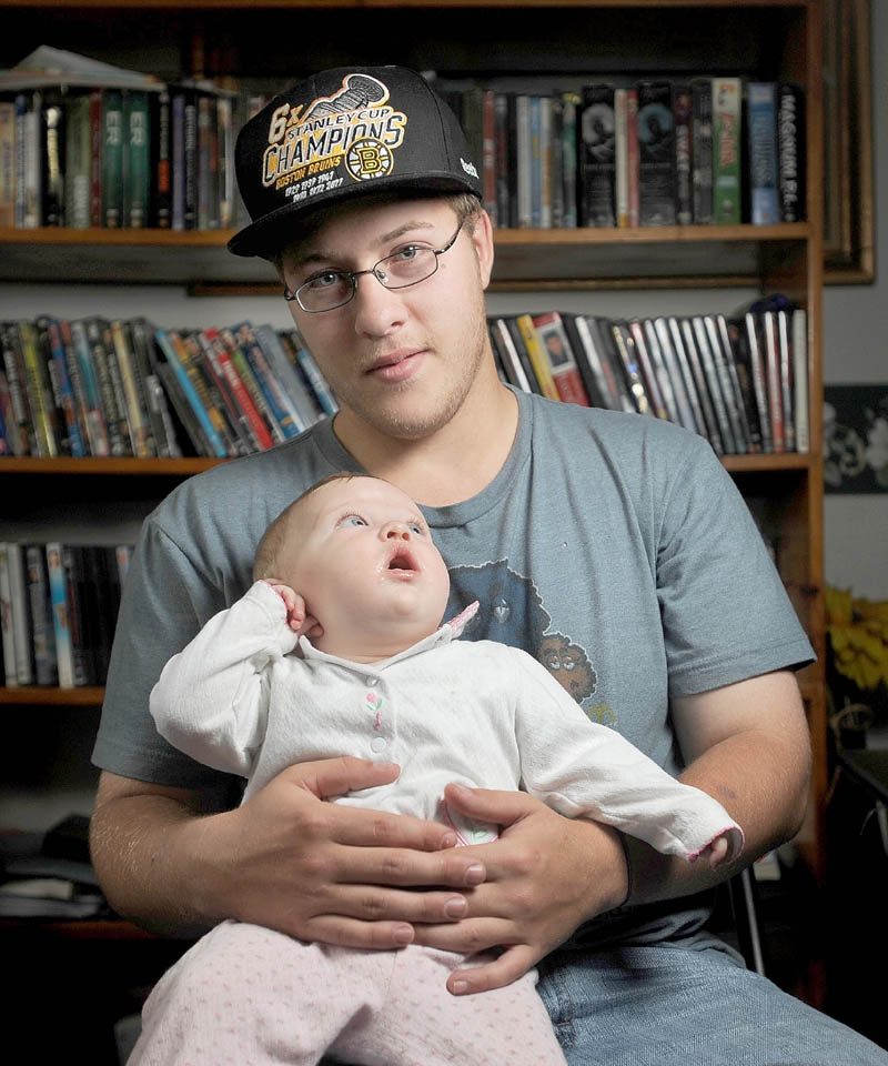 Kevin Hardy with his infant daughter, Zoey, on Friday.