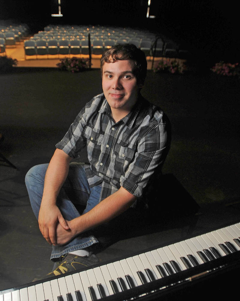 Zander Walz, 26, sits by the piano he will be playing during the Skowhegan Area Adult and Community Education graduation ceremony at Skowhegan Area High School on Wednesday. Walz received a GED and will attend Kennebec Valley Community College in the fall to study radiology.