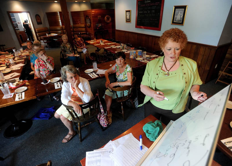 Kay Grindall teaches the finer points of shorthand to the Shorthand Writers of Maine during lunch at the Weathervane Restaurant on Kennedy Memorial Drive in Waterville on Friday.