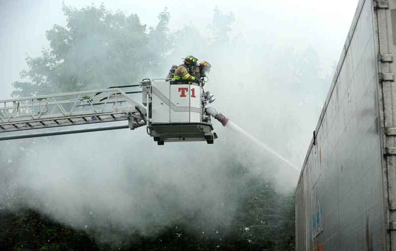 Waterville Fire Department firefighters battle a trailer fire at Pine Tree Pine Tree Waste Services on Airport Road in Waterville, after a powerful thunderstorm rolled through central Maine on Wednesday. The fire was believed to be caused by a lightning strike.