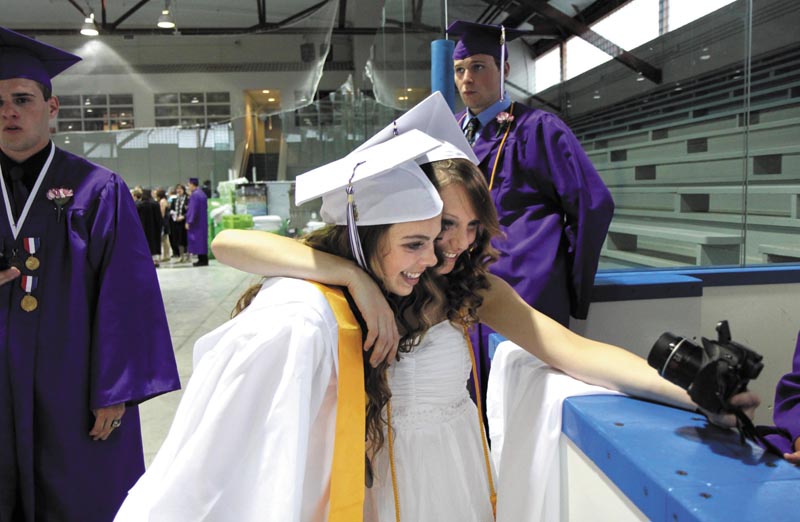 Waterville Senior High School seniors Georgia Bolduc, left, and Katie Connelly take a self portrait before the 135th commencement exercises at Wadsworth Gymnasium at Colby College in Waterville on Thursday night.