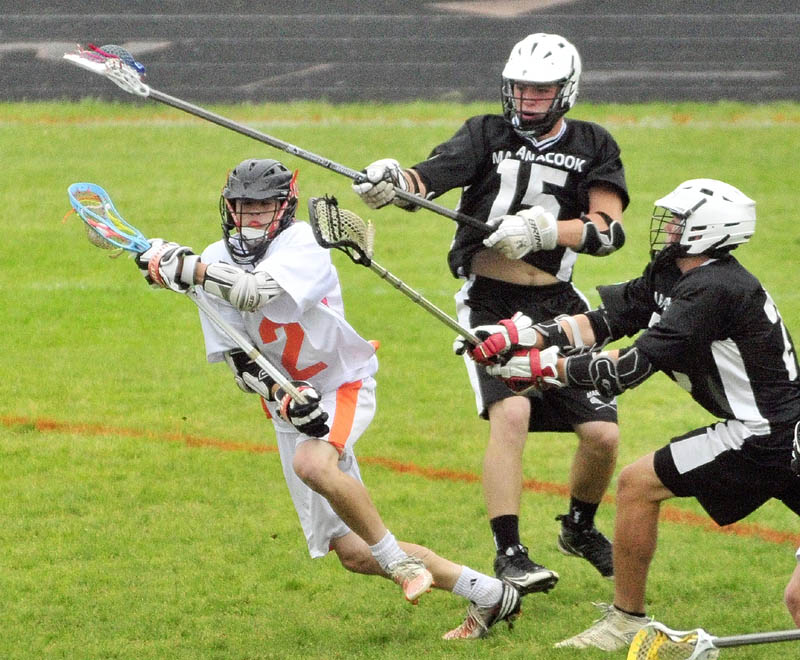 TAKE THE SHOT: Gardiner’s Keegan Smith, left, goes in for a shot in front of Maranacook/ Winthrop’s Simon Davis, center, and Zachary Godbout during the Tigers’ 13-9 win in an Eastern B semifinal game Friday at Hoch Field in Gardiner.