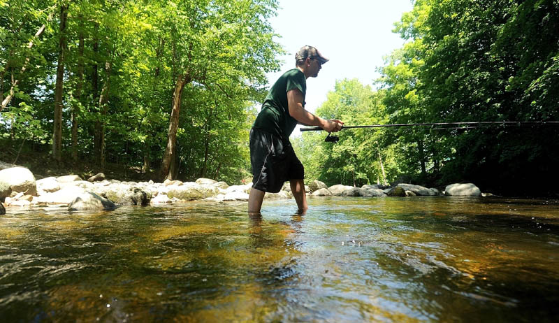 Dan Tracy, 28, of Oakland, takes advantage of the sunny weather and fishes the Messalonskee Stream just below Messalonskee Lake in Oakland on Friday. "The kids are at the grandparents, which means I'm going fishing," Tracy said.