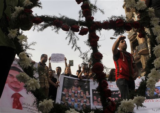 Egyptian Christian are seen through a cross during a memorial march for the killed Christians in clashes between Muslims and Christians in April in Cairo, Egypt, on May 24.