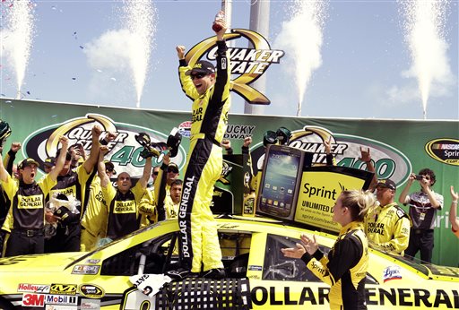 Matt Kenseth celebrates with his crew members in the winner's circle after capturing the NASCAR Sprint Cup auto race at Kentucky Speedway on Sunday in Sparta, Ky. NASCAR