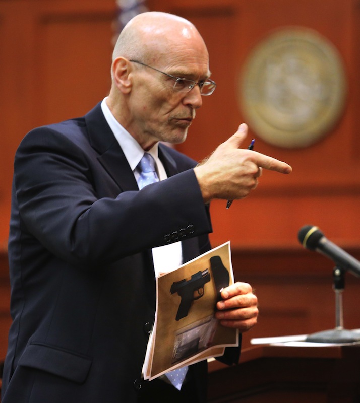 Don West, a defense attorney for George Zimmerman describes the shooting of Trayvon Martin to the jury while holding an evidence photo of a gun during opening statements in Zimmerman's trial in Seminole circuit court, in Sanford, Fla., Monday, June 24, 2013. Zimmerman has been charged with second-degree murder for the 2012 shooting death of Trayvon Martin. (AP Photo/Orlando Sentinel, Joe Burbank,Pool)