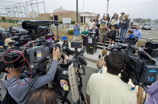Activists gather for a news conference outside the San Onofre Nuclear Generating Station in San Clemente, Calif., Friday morning, after it was announced that the nuclear plant will be closing permanently.