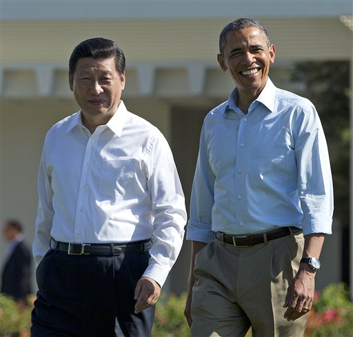 President Barack Obama and Chinese President Xi Jinping, left, walk at the Annenberg Retreat of the Sunnylands estate Saturday in Rancho Mirage, Calif. While saying it is critical that the U.S. and China reach a "firm understanding" on cyber issues, Obama told reporters his meetings with Xi have been "terrific."