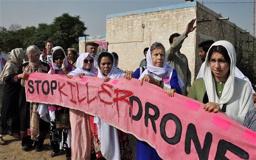 In this Oct. 7 file photo, American citizens hold a banner during a peace march organized by Pakistan's cricket star turned politician Imran Khan's party, not pictured, in Tank, Pakistan.