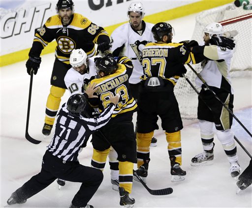 Linesman Brad Kovachik works to separate Pittsburgh Penguins left wing Brenden Morrow (10) and Boston Bruins left wing Brad Marchand (63) as they tangle in the second period of Game 4 in the Eastern Conference finals of the NHL hockey Stanley Cup playoffs, in Boston on Friday.