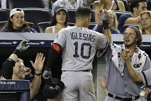 Boston Red Sox's Mike Carp, left, and Jarrod Saltalamacchia greet Jose Iglesias (10) at the dugout steps after Iglesias hit a fifth-inning solo home run off New York Yankees starting pitcher Hiroki Kuroda (18) in a baseball game at Yankee Stadium in New York, Sunday, June 2, 2013. (AP Photo/Kathy Willens)