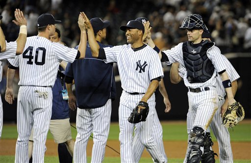 New York Yankees pitcher Mariano Rivera and catcher Chris Stewart, right, celebrate with teammates after the Yankees defeated the Boston Red Sox, 4-1, in a baseball game Friday, May 31, 2013, at Yankee Stadium in New York. (AP Photo/Bill Kostroun)