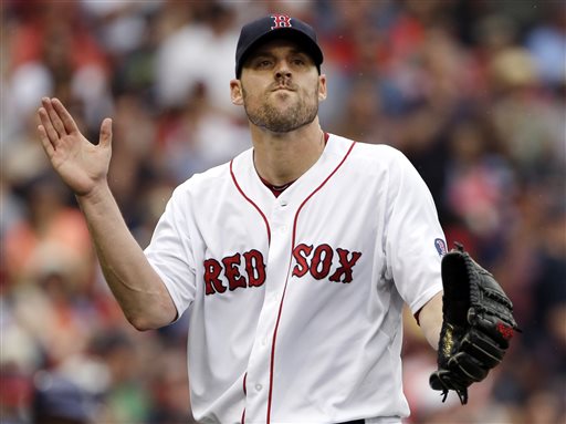 Boston Red Sox starting pitcher John Lackey claps after striking out Colorado Rockies' Tyler Colvin to end the top of the fourth inning of an interleague game Wednesday at Fenway Park in Boston. Fenway Park