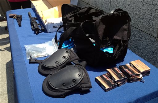 Weapons and other evidence recovered from the gunman in Friday's deadly shooting rampage that left four people dead, in Santa Monica, Calif., are displayed Saturday in Santa Monica.