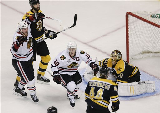 Chicago Blackhawks left wing Bryan Bickell (29) and center Jonathan Toews (19) celebrate the winning goal by Brent Seabrook, not shown, against Boston Bruins goalie Tuukka Rask (40), of Finland, during the first overtime period in Game 4 of the NHL hockey Stanley Cup Finals, Wednesday, June 19, 2013, in Boston. (AP Photo/Charles Krupa) TD Garden