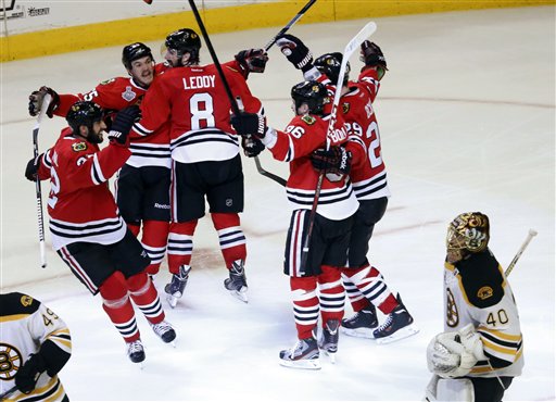Chicago Blackhawks center Andrew Shaw, second from left, celebrates with his teammates after scoring the winning goal during the third overtime period of Game 1 in their NHL Stanley Cup Final hockey series against the Boston Bruins, Thursday, June 13, 2013, in Chicago. The Blackhawks won 4-3. (AP Photo/Charles Rex Arbogast) United Center