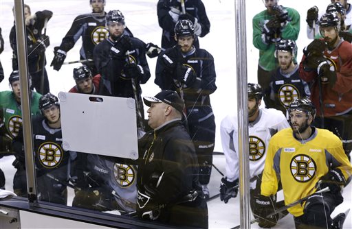 Boston Bruins players gather around head coach Claude Julien as he uses a board during practice at TD Garden in Boston on Monday. The Bruins are preparing to face the Chicago Blackhawks in the Stanley Cup finals with Game 1 scheduled for Wednesday in Chicago. TD Garden