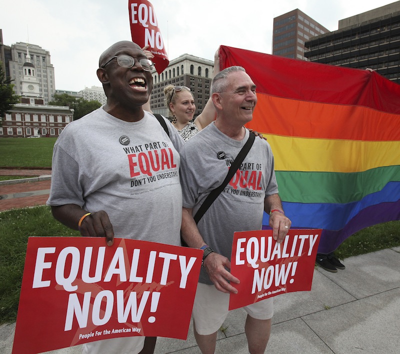 Stevie Martin-Chester, left, and his husband of 20 years, Arthur Martin-Chester, from Norristown, attend a rally in support of Wednesday's landmark Supreme Court rulings on gay marriage Wednesday, June 26, 2013, at Independence Mall in Philadelphia. (AP Photo/Philadelphia Daily News, Steven M. Falk) 304d50305756384c;696e717763