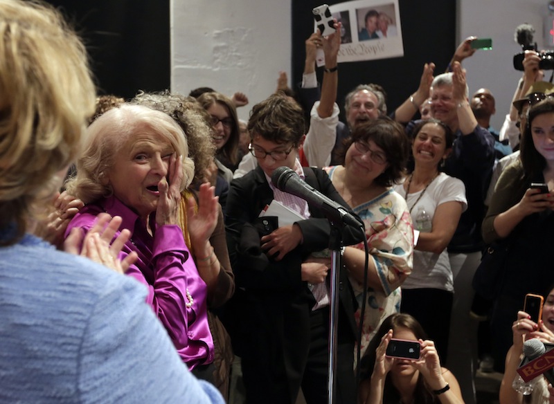 Edith Windsor, left, the plaintiff in the historic gay marriage case that was before the U.S. Supreme Court, wipes her eyes after addressing supporters at the LGBT Center, in New York, Wednesday, June 26, 2013. In a major victory for gay rights, the Supreme Court on Wednesday struck down a provision of a federal law denying federal benefits to married gay couples and cleared the way for the resumption of same-sex marriage in California. (AP Photo/Richard Drew)