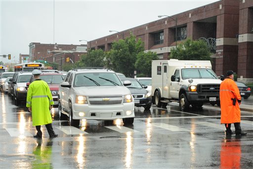 Police officers direct traffic next to the Stuart C. Siegel Center at Virginia Commonwealth University in Richmond, Va. on Friday. Tropical Storm Andrea doused the area with ample rainfall as the arena hosted graduations for local high schools.