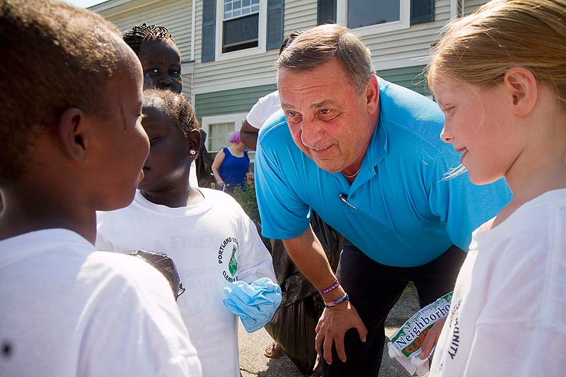 Governor Paul LePage talks with children during his visit to the Wellesley Estate in Portland during the Portland Community Cleanup Day on Saturday.