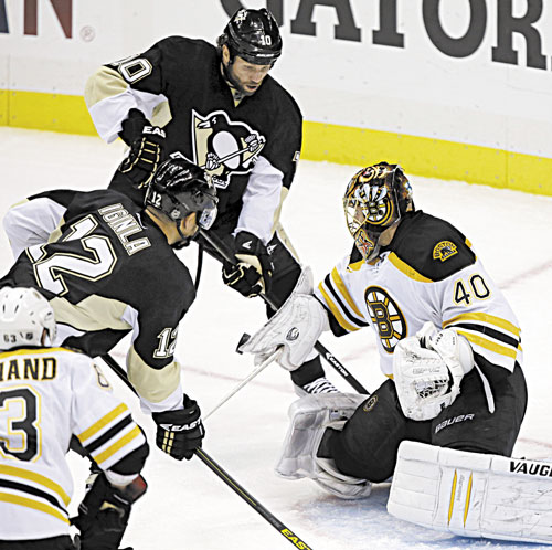 WALL: Boston Bruins goalie Tuukka Rask (40) blocks a shot in front of Pittsburgh’s Brenden Morrow (10) and Jarome Iginla (12) during Game 2 of the Eastern Conference finals Monday in Pittsburgh. Rask has stopped 55 of 56 shots in the series.