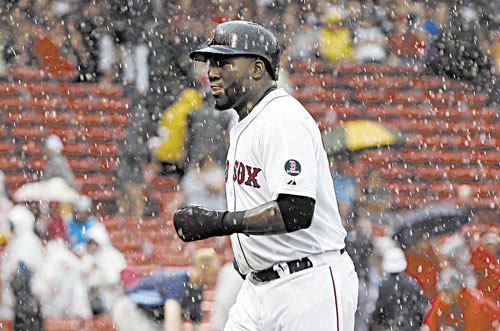 GET OUT OF HERE: Boston’s David Ortiz jogs off the field during a rain delay in the fifth inning against the Tampa Bay Rays in the first game of a doubleheader Tuesday in Boston.