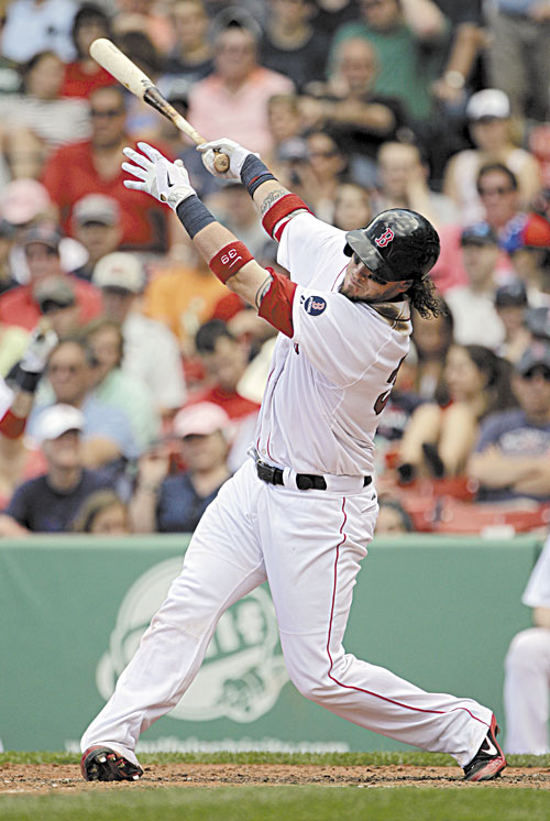 1ST OF TWO: Boston’s Jarrod Saltalamacchia follows through on a home run during the sixth inning against the Los Angeles Angels on Sunday at Fenway Park in Boston. Saltalamacchia hit two home runs in the Red Sox 10-5 win.