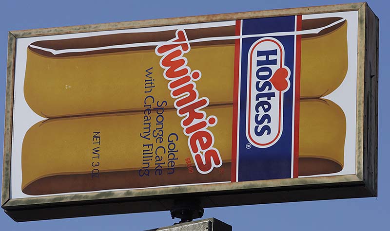 FILE - A Hostess Twinkies sign is shown at the Utah Hostess plant in Ogden, Utah, in this Nov. 15, 2012 file photo. Hostess Brands Inc. says it's in talks with more than 100 parties interested in buying its brands, which include Twinkies, Ding Dongs and Ho Hos. (AP Photo/Rick Bowmer, File)