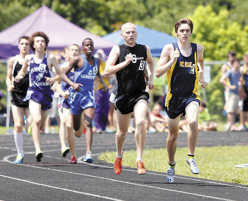 Justin Tracy of Mt. Blue High School leads a pack of runners before being passed by race winner Robert Hall of Scarborough High School during the boy's 1600 meter run at the Class A state championship meet Saturday in Brewer.