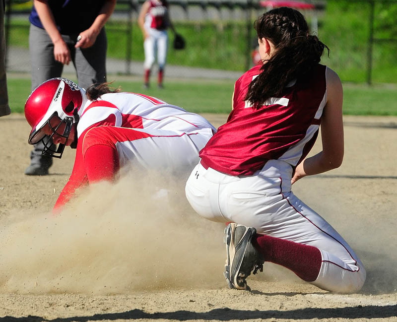 Staff photo by Joe Phelan Cony's Kassidy Turgeon, left, is safely on third base before Bangor's shortstop Syndi Cosgrove can apply tag during a game on Wednesday June 5, 2013 at Cony Family Field in Augusta.