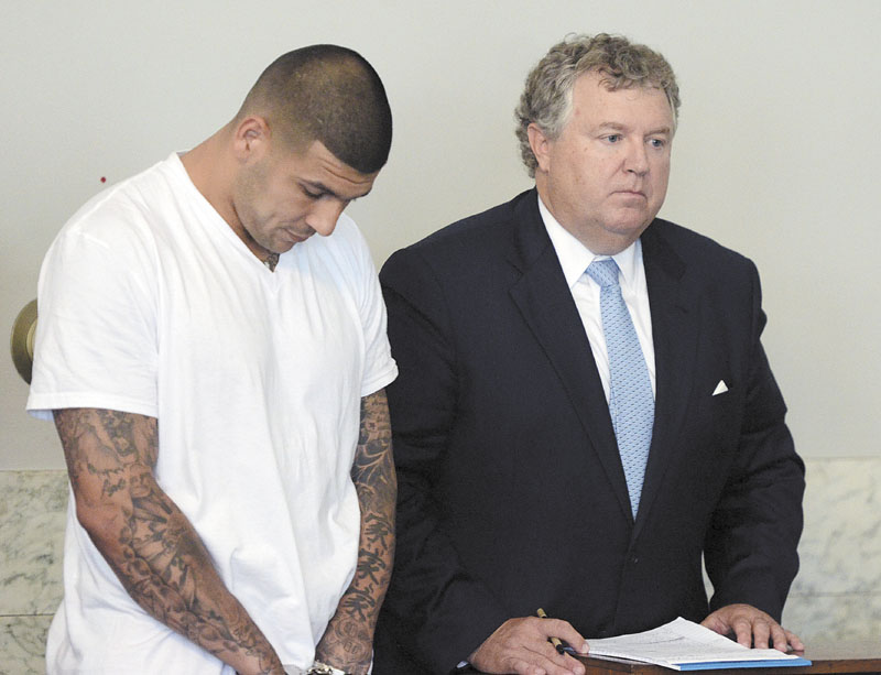 HERNANDEZ CHARGED: Former New England Patriots tight end Aaron Hernandez, left, stands with his attorney Michael Fee, right, during arraignment in Attleboro District Court on Wednesday in Attleboro, Mass. Hernandez was charged with murdering Odin Lloyd, a 27-year-old semi-pro football player for the Boston Bandits, whose body was found June 17 in an industrial park in North Attleborough, Mass.