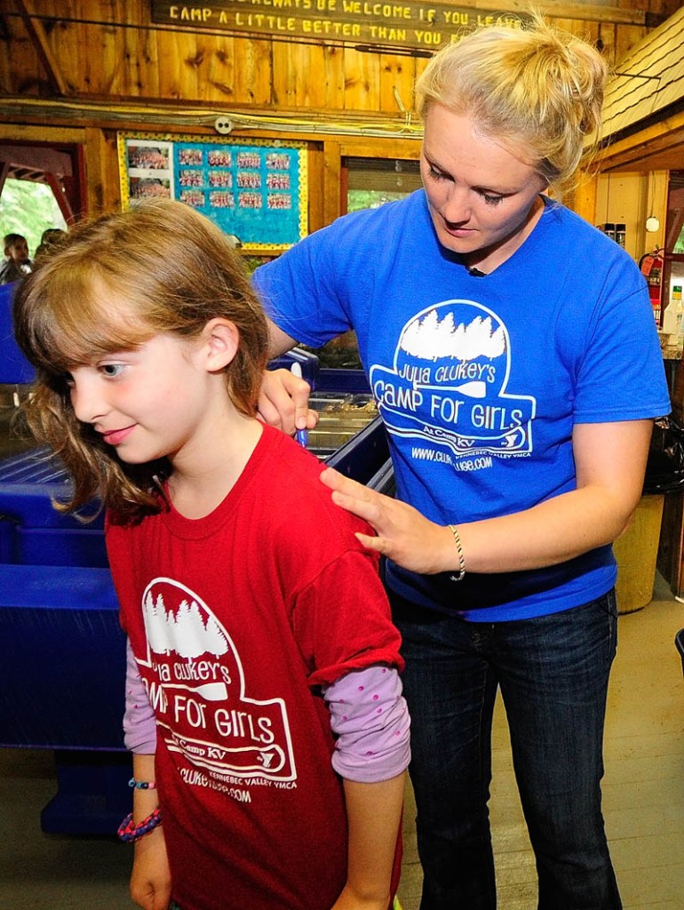 A SIGNATURE MOMENT: Emily Curtis of Brunswick gets an autograph on the back of her camp shirt from Julia Clukey on Thursday at Julia Clukey’s Camp for Girls at Camp KV in Readfield.
