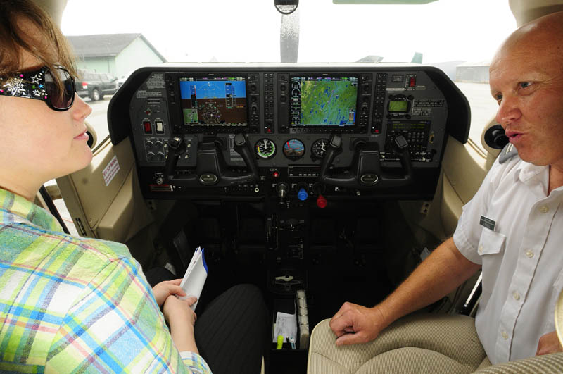 Courtney Oliver, 21 of Winthrop, left, sits in an airplane cockpit and learns about joining the Civil Air Patrol from Civil AIr Patrol Capt. Steve Vorpagel on Saturday at the Augusta State Airport.