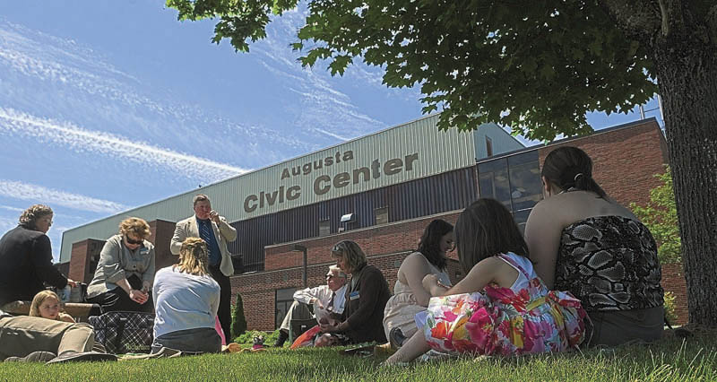 People enjoy an outdoor lunch break during the Jehovah's Witnesses district convention on Friday at the Augusta Civic Center.