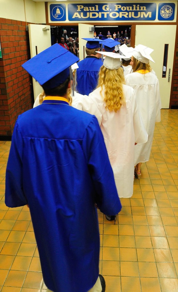 Graduates file into the Paul G. Poulin Auditorium at the start of Erskine Academy's commencement on Friday at the Augusta Civic Center.