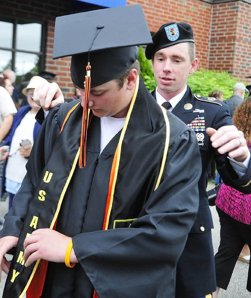 Senior Chris Allen, of West Gardiner, left, gets a hand adjusting his U.S. Army sash from Staff Sgt. Matthew Benson before the Gardiner Area High School commencement ceremony on Saturday at the Augusta Civic Center. Allen, one of four seniors joining the Army, said he plans to be an infantryman.